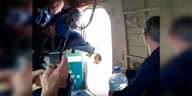Sacerdote arroja agua bendita desde avión