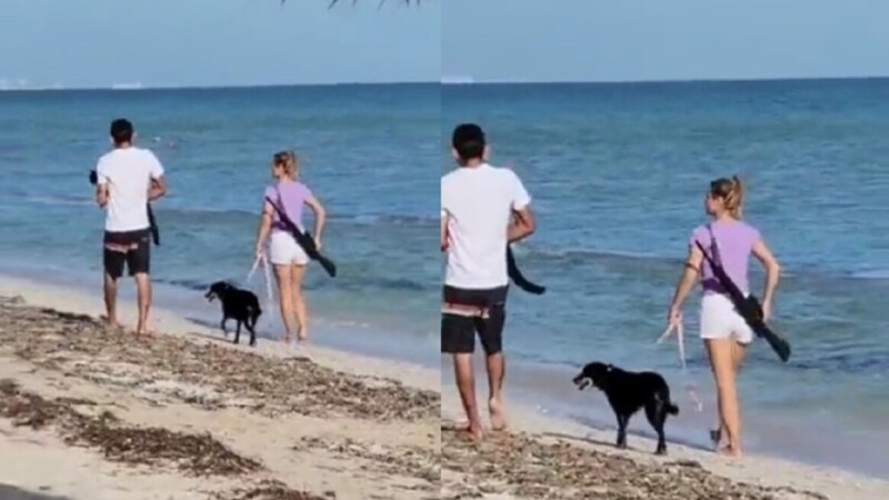 Mujer pasea con un rifle en playas de Puerto Progreso