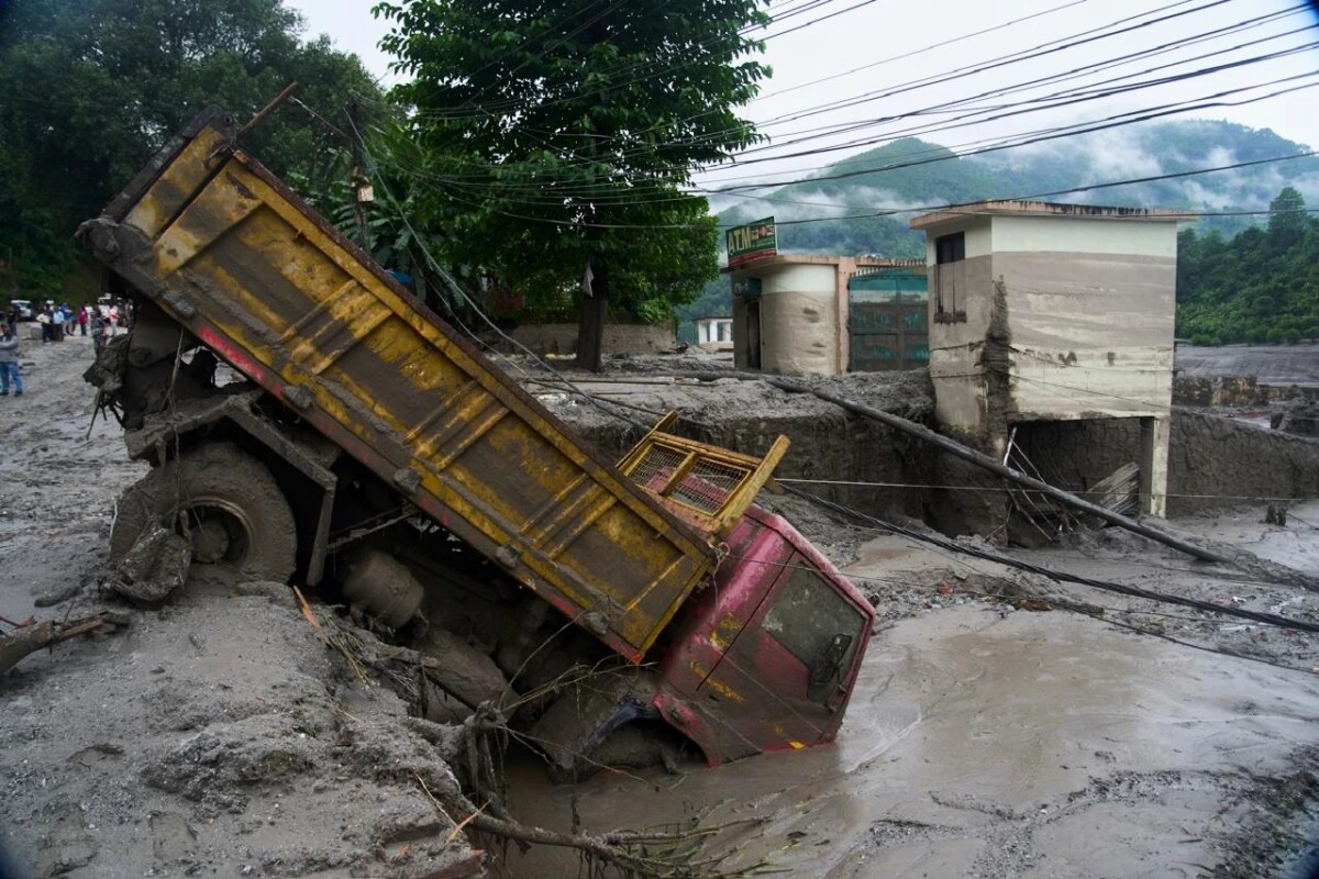 Un vehículo quedó aprisionado en una hondonada, tras las inundaciones repentinas registradas en Devighat, en el distrito de Nuwakot, Nepal, el 27 de agosto de 2026.  